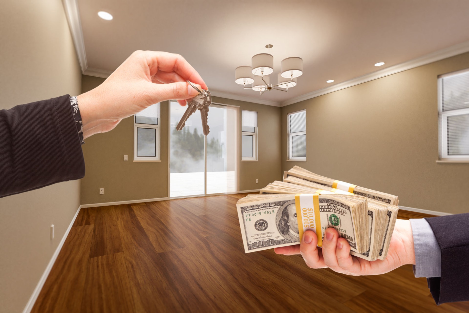 Agent Handing Over House Keys for Cash in Newly Remodeled Room of House.